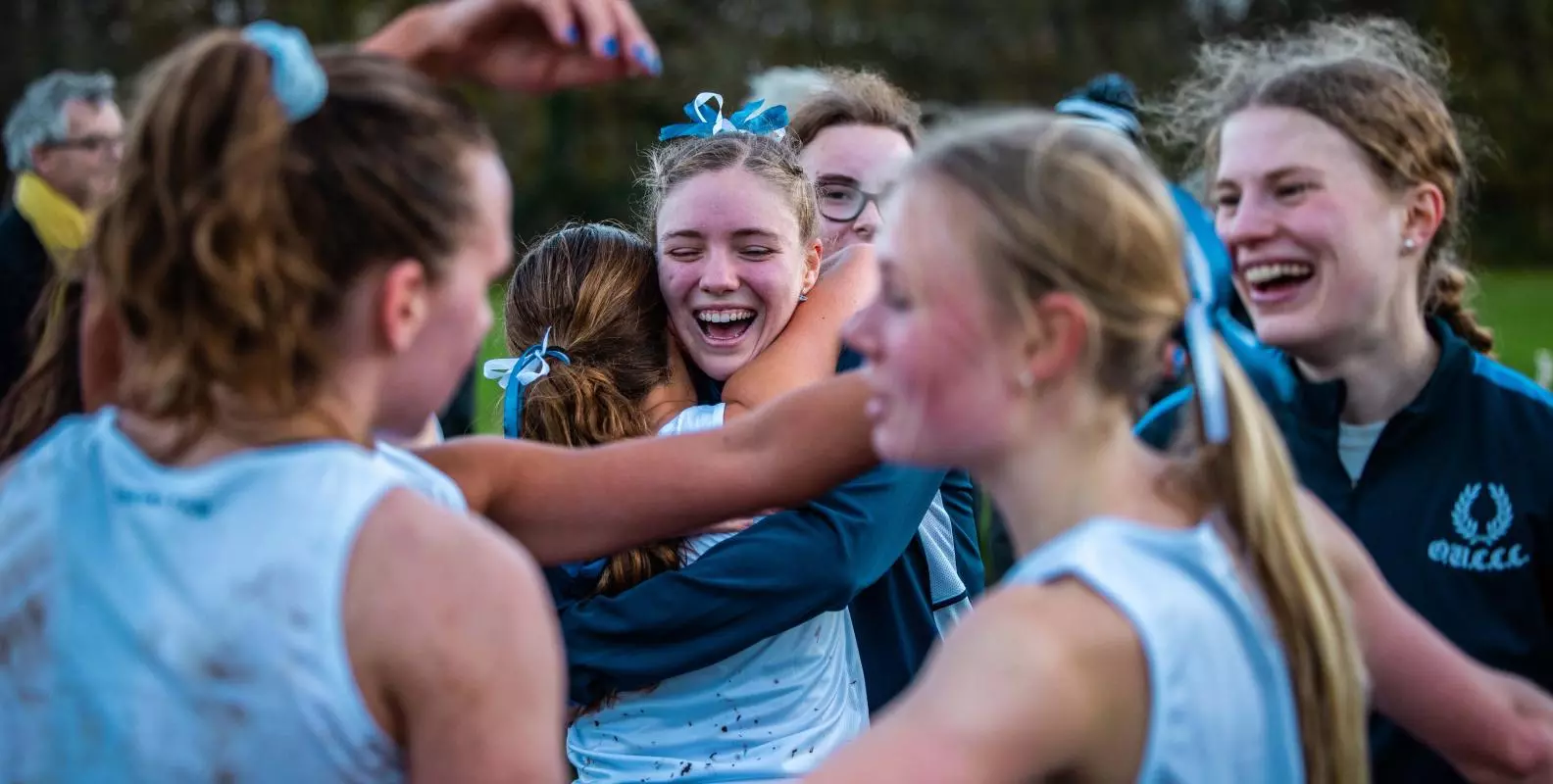 women's blues celebrating varsity win