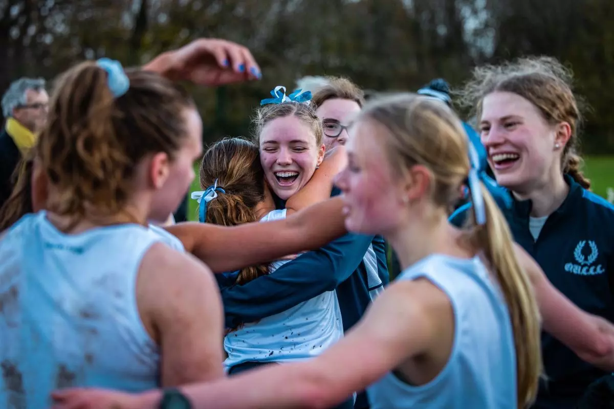 women's blues celebrating varsity win